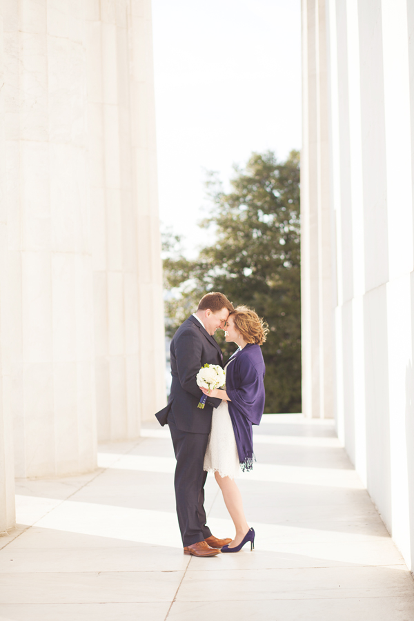 couple standing in pillars looking at each other