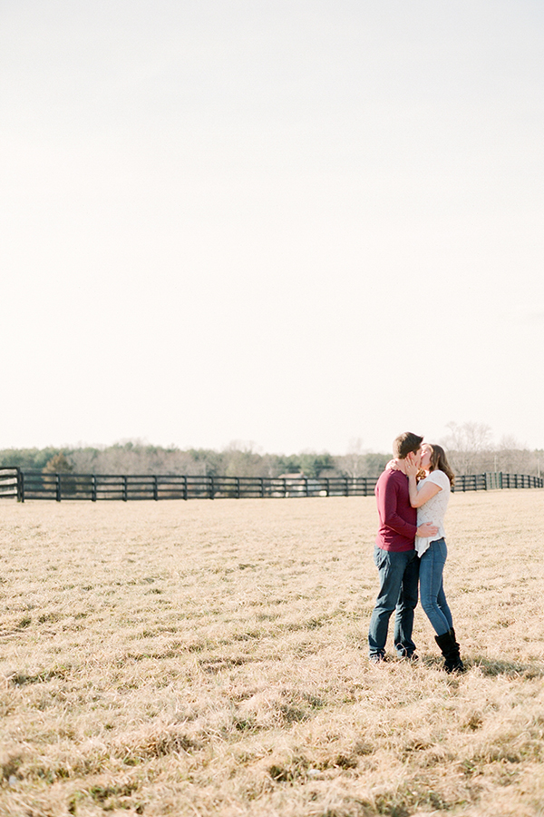 couple kissing in field