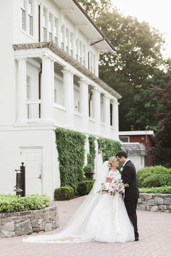 Bride and groom outside mansion