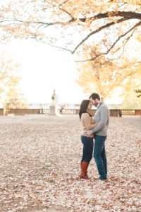 couple holding each other under autumn tree