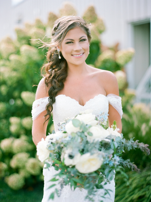 Smiling bride holding bouquet 
