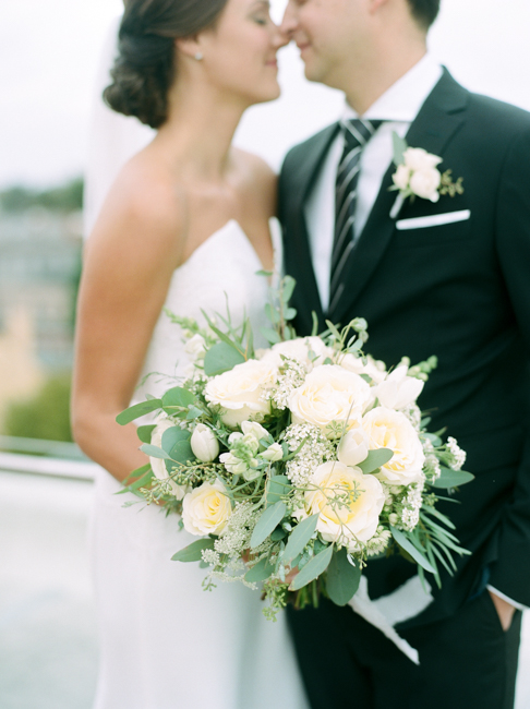bride holding cream flowers