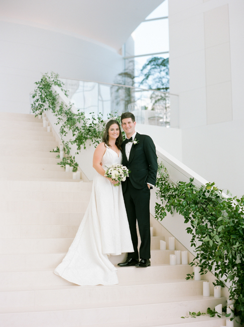 bride and groom pose on stairs
