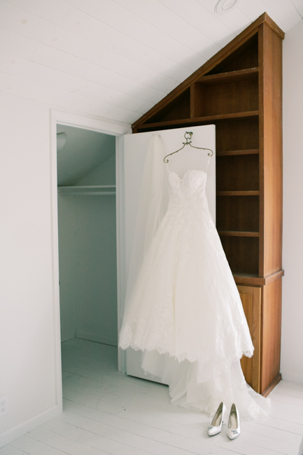 wedding dress hanging on door