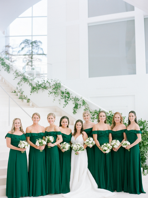 bride stands with bridesmaids