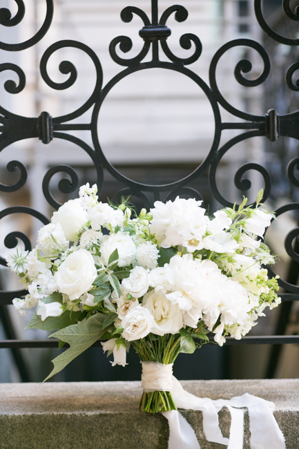 white bridal bouquet leaning against an ornate wrought iron railing at an Anderson House Wedding in Washington DC