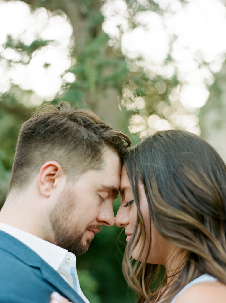 couple leaning their heads together during their engagement session at The Washington National Cathedral
