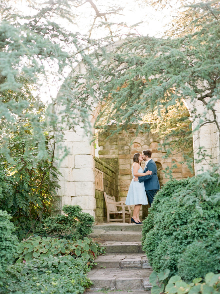couple kissing in the garden during their engagement session with astrid photography